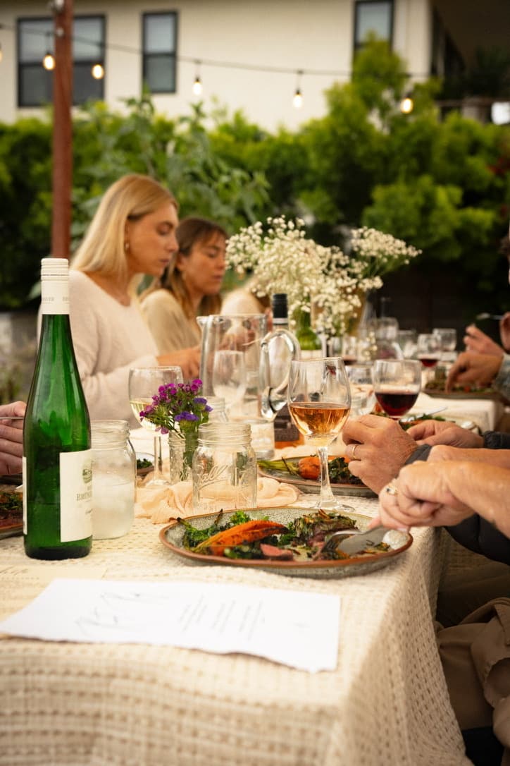 A long communal table at dusk